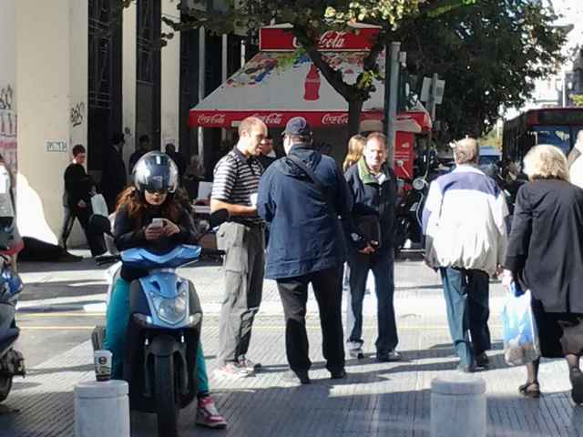 Talking to a man in the square.