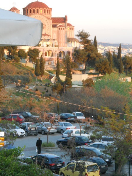 Greek Orthadox praying toward his church